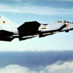 An air-to-air right side view of a Soviet MiG-31 Foxhound aircraft.