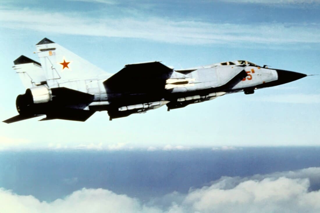 An air-to-air right side view of a Soviet MiG-31 Foxhound aircraft.