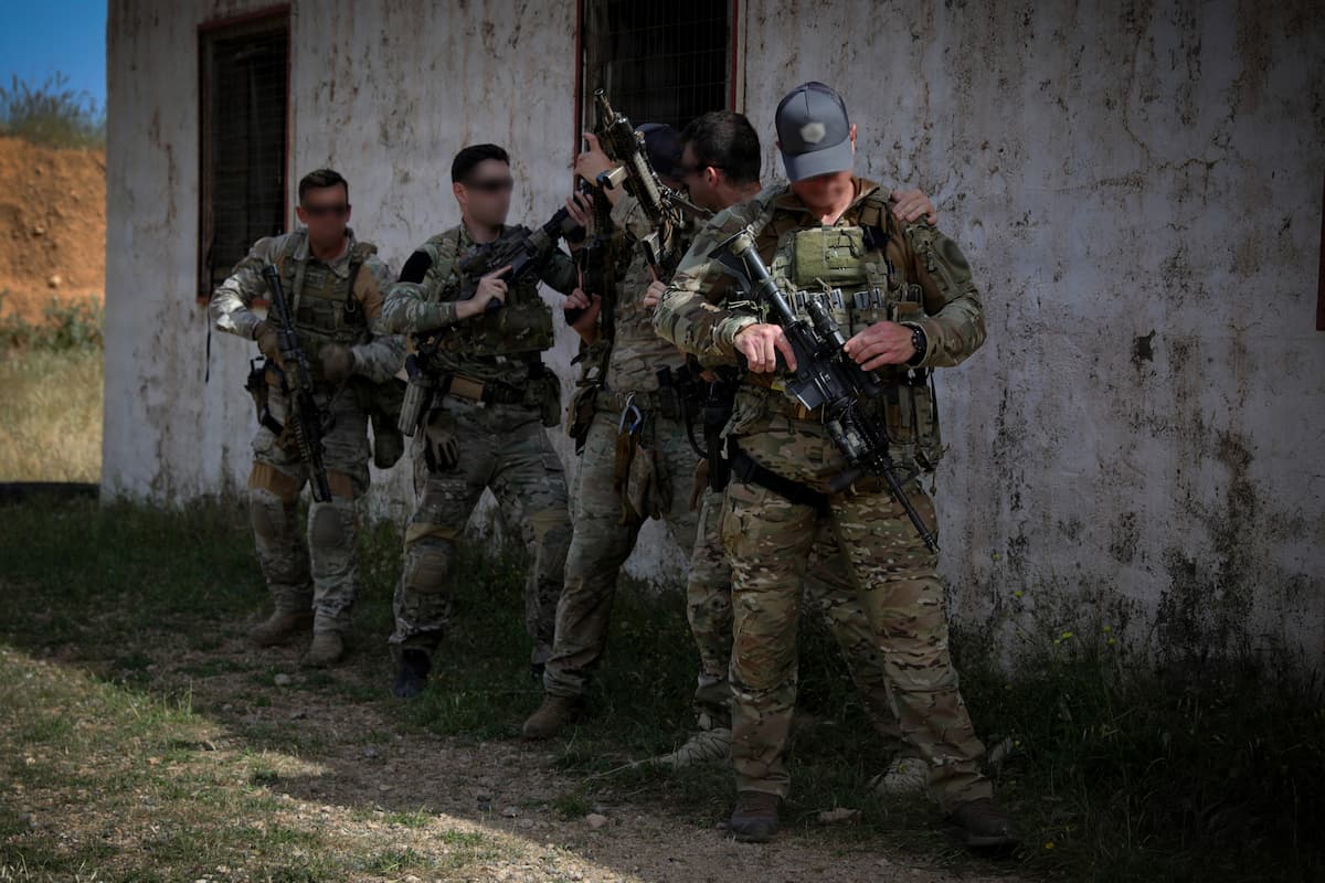 Greek army special operations soldiers stacked at a doorway preparing to clear a room