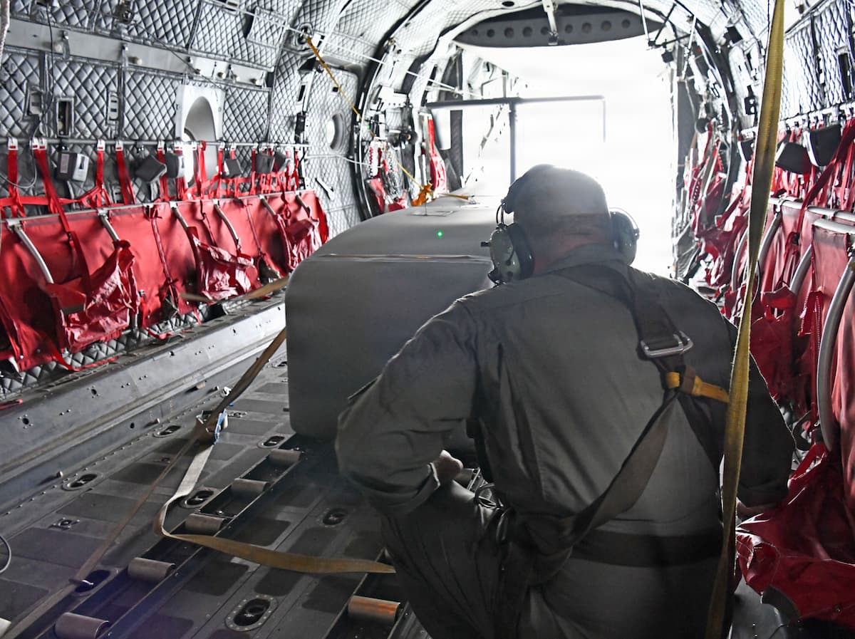 Romanian Air Force personnel preparing to launch a Grasshopper aerial resupply glider from a C-27J Spartan