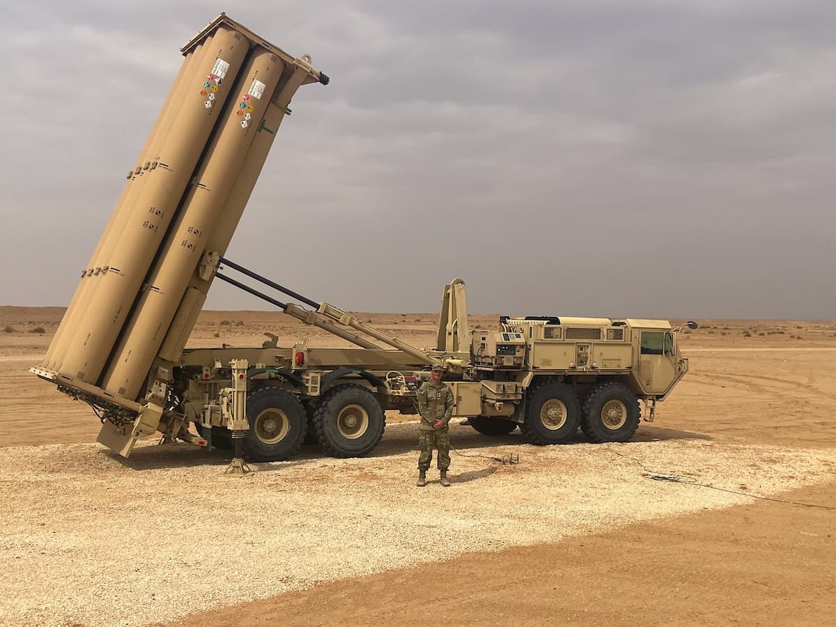 A soldier stands in front of an emplaced THAAD launcher prepared to fire interceptors