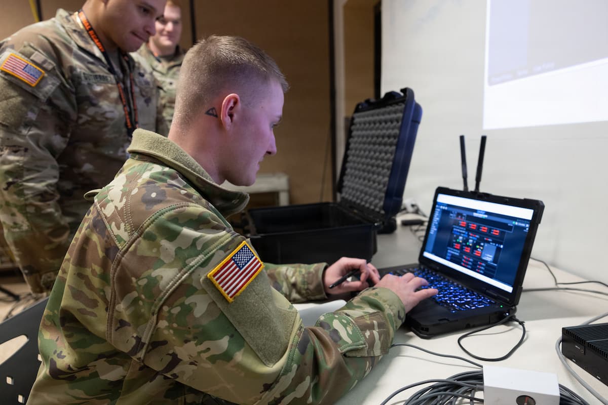 Two soldiers of the 124th Division Signal Battalion, 4th Infantry Division, establish network connections with Next Generation Command and Control equipment during Ivy Sting IV at Fort Carson, Colorado, Jan. 30, 2026.